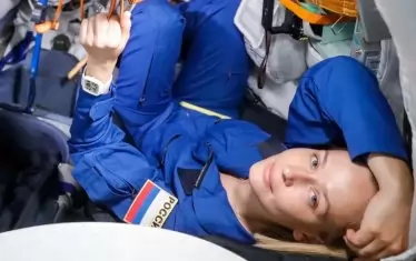 Актрисата Юлия Пересилд на тренажора на кораба "Союз" се готви за полет до МКС. 