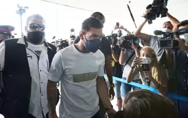 Меси преминава безмълвно край чакащите журналисти, фотографи и оператори преди да отпътува от Барселона за френската столица.