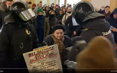 Арестът на Елена Осипова на 2 март заради саморъчни антивоенни плакати. Тълпата зад нея скандира "Не на войната!"