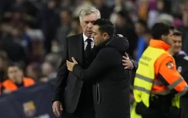 Треньорът на "Реал" Карло Анчелоти (вляво) казва окуражителни думи на разочарования си колега от "Барселона" Шави Ернандес след края на реванша от 1/2-финалите за Купата на краля.