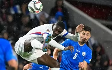 Френският нападател Рандал Коло Муани (в бяло) се опитва да овладее топката при победата на "петлите" с 4:1 в гостуването им срещу Израел, което се игра в Будапеща.
