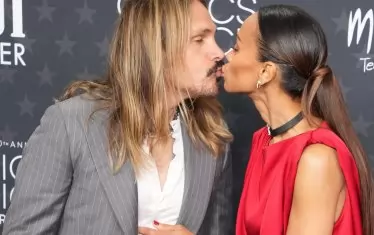 Зоуи Салдана целува съпруга си Марко Перего, преди да получи "Изборът на критиците".