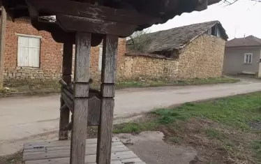 Кладенец на мегдана, зад него едно от характерните неща в Стефан Стамболово (Градина) - каменна къща.