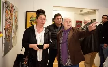  Художникът сред гостите на галерията по време на откриването.